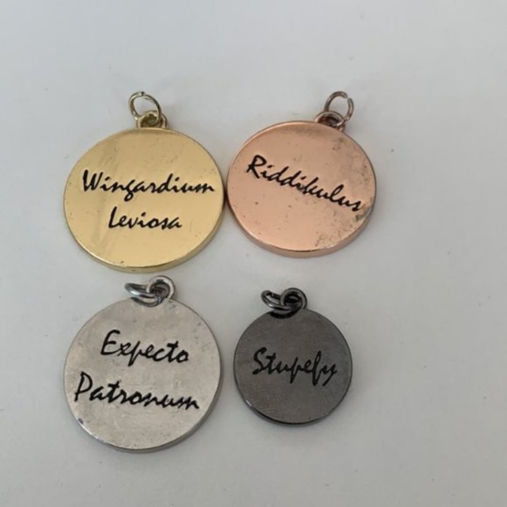 Set of four graduated sizes round Harry Potter Charms Pendants WBEI (s18)